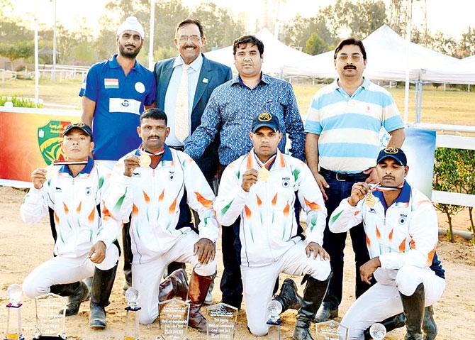 The Indian equestrian team pose with their medals