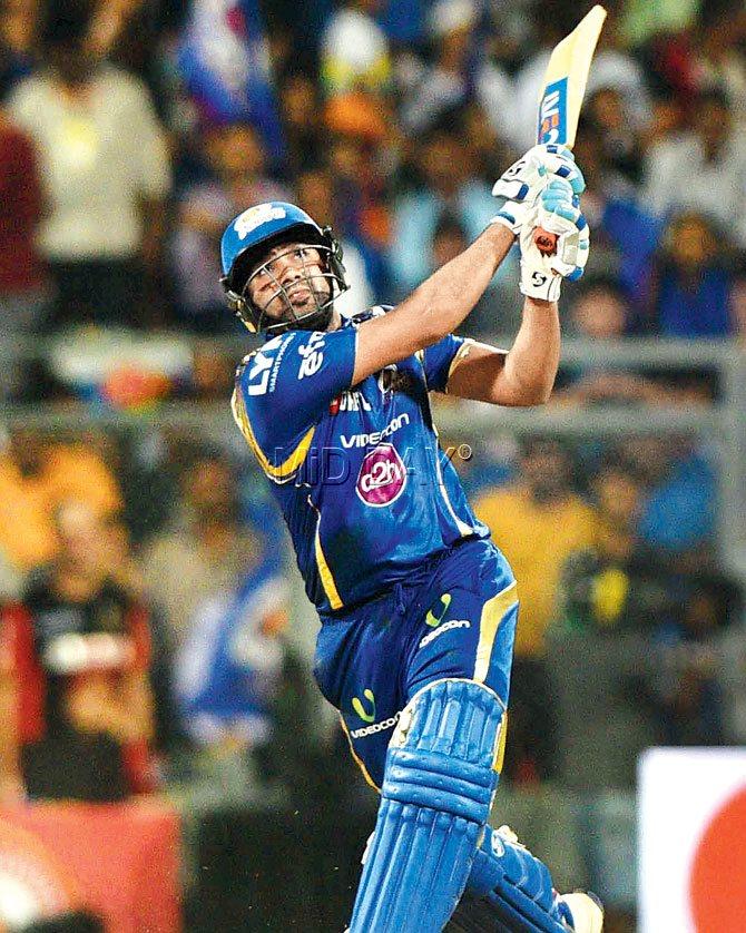 Mumbai Indians skipper Rohit Sharma hits one over the fence during his 44-ball 62 vs RCB at Wankhede on Wednesday. Pic/Suresh Karkera