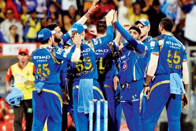 Mumbai Indians celebrate the wicket of RCB’s KL Rahul at Wankhede on Wednesday. PIC/SURESH KARKERA