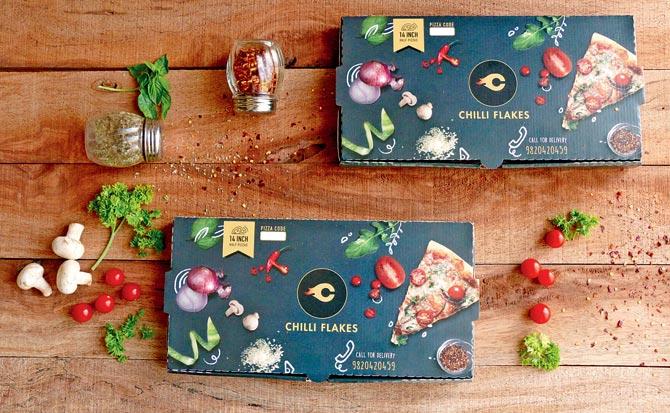 the pizzas arrive in sturdy, customised half pizza boxes