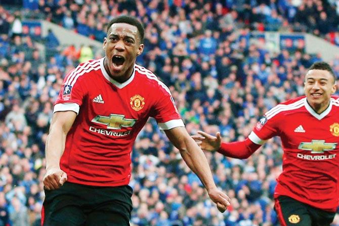 Manchester United striker Anthony Martial (left) celebrates with teammate after scoring his team’s winning goal during the FA Cup semi-final match against Everton at Wembley Stadium in London on Saturday. pic/AFP