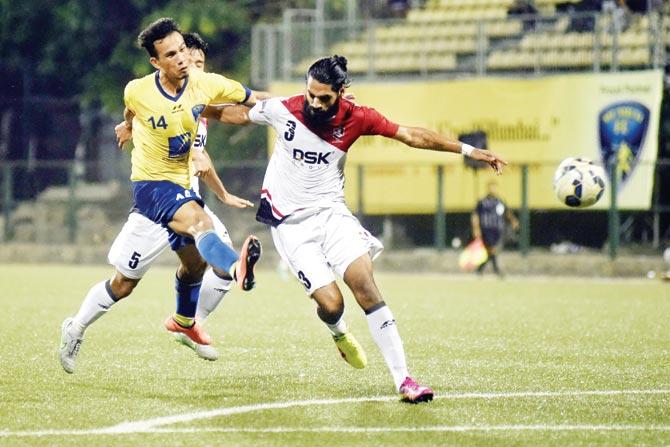 Mumbai FC’s Sushil Kumar Singh (in yellow) shoots even as he is tackled by DSK Shivajians Sandesh Jhingan during their Hero  I-League match at Cooperage yesterday. Pic/ATUL KAMBLE