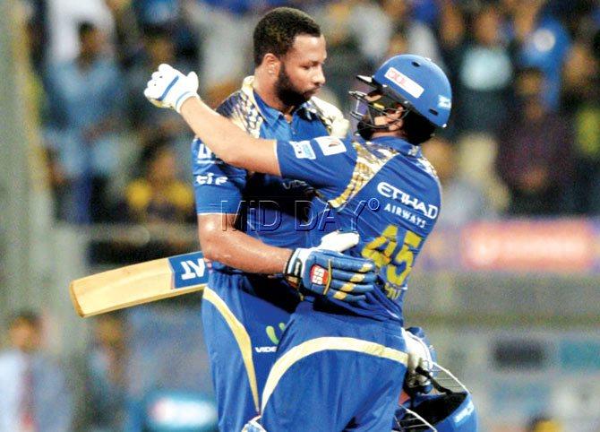 Kieron Pollard (left) celebrates MI’s win over KKR with Rohit Sharma on Thursday. Pic/Suresh Karkera
