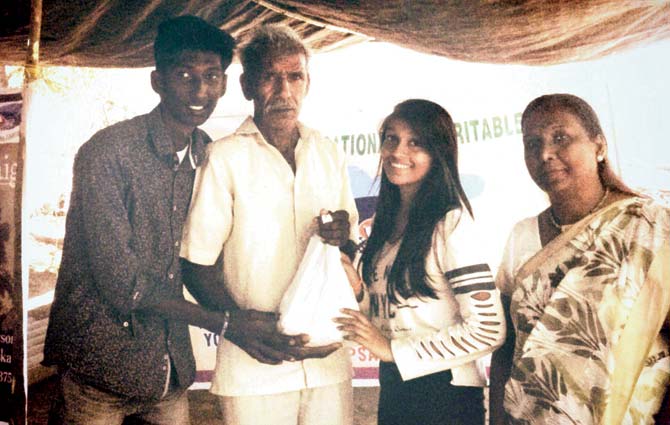 Offering donations in kind to farmers during a village visit