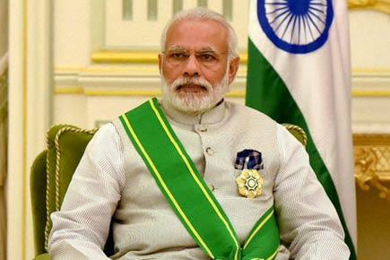 Scribe posts Narendra Modi's photo bowing before Saudi King, BJP files complaint