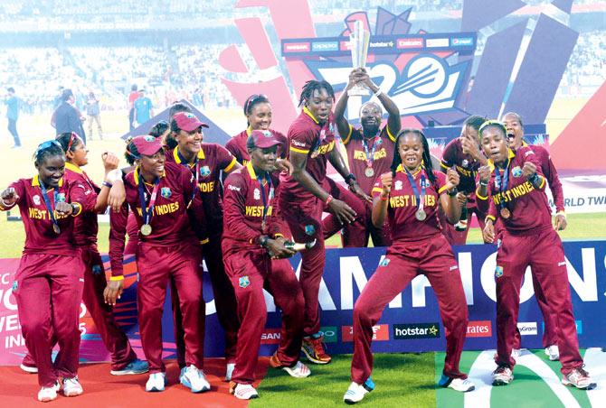 West Indies cricketers celebrate after winning the women