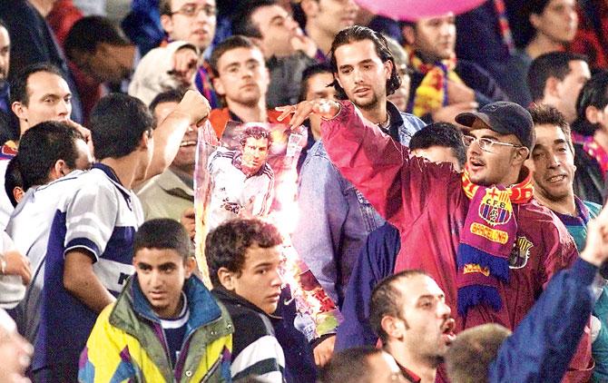 October 21, 2000: Barcelona fans burn a poster of Luis Figo during the Spanish League match between Barcelona and Real Madrid at the Nou Camp in Barcelona. Figo, who had left the Catalonia club to join Real, was playing in Barcelona for the first time since his move. Pic/AFP