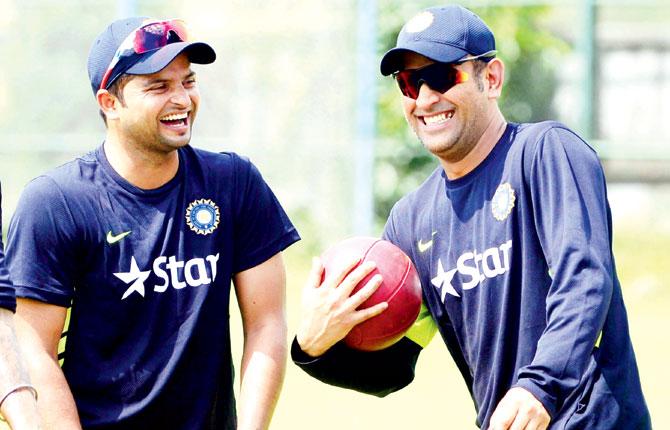 Suresh Raina (left) with MS Dhoni in Mirpur last year. Pic/AFP