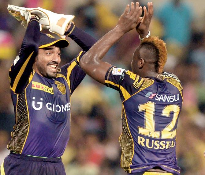 Kolkata Knight Riders’ Andre Russell (right) celebrates the wicket of Delhi Daredevils’ Shreyas Iyer with his teammate Robin Uthappa during the IPL match at Kolkata’s Eden Gardens yesterday. KKR won by nine wickets and 35 balls to spare. Pics/AFP