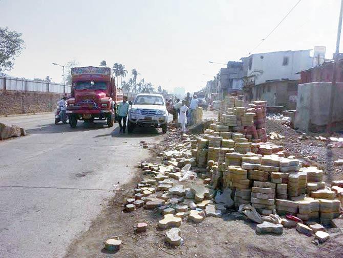BMC workers remove unattended paver blocks from the Ghatkopar-Mankhurd Link Road, which leads to the Deonar landfill