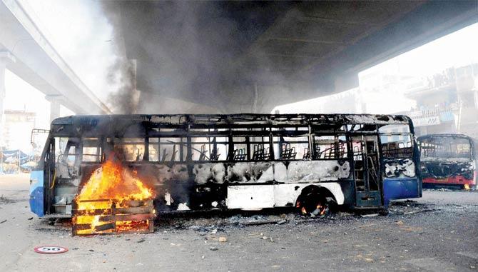 Charred buses which were torched by garment workers during a protest rally over the EPF withdrawal norm