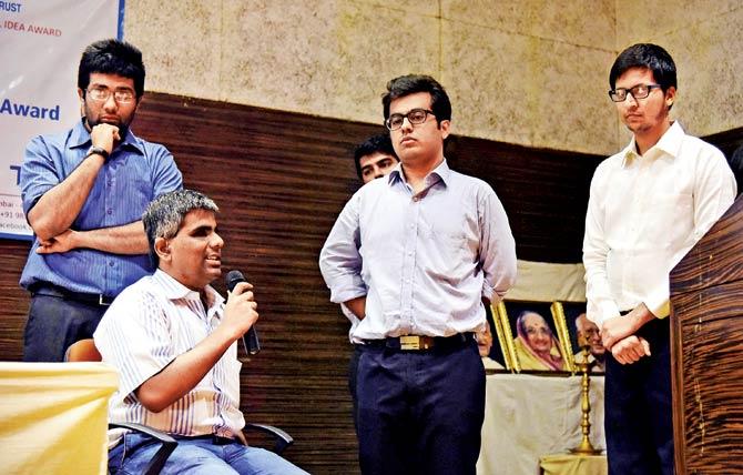 A group of students along with the visually impaired entrepreneur present their ideas