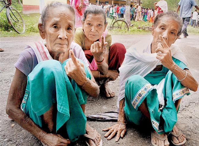 Bodo women show their inked fingers after casting votes in Baska, Assam. Pics/PTI