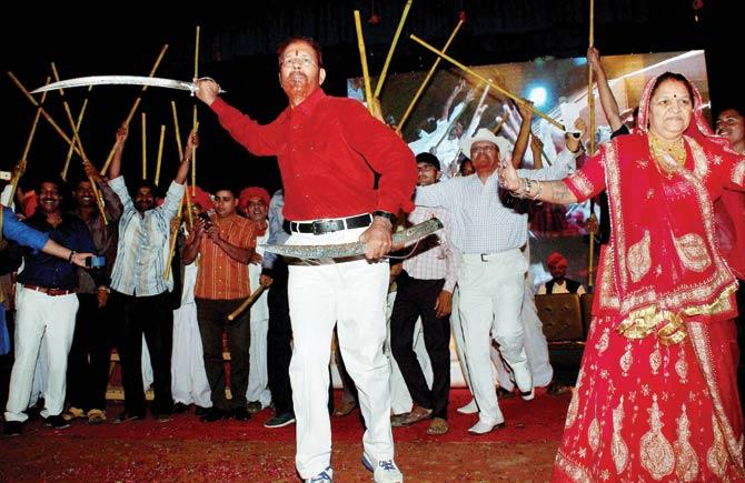 Former IPS officer DG Vanzara dances with a sword during a welcome ceremony thrown by his family and community in Gandhinagar on April 8. Pic/PTI