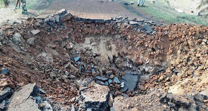 A crater formed on the road as a result of a blast triggered by Naxals in an attack on a CRPF convoy at Malewada in Dantewada on Wednesday. PicPTI 
