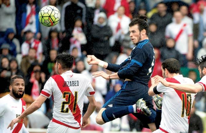 Real Madrid’s Welsh striker Gareth Bale (in dark blue) rises above a couple of Rayo Vallecano defenders to score during their Spanish League match at the Vallecas Stadium in Madrid on Saturday. Pics/AFP