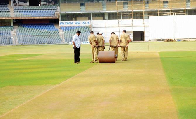 Groundsmen prepare the pitch at the storied Wankhede Stadium in Mumbai, which might not be able to host the IPL final on May 29 if the petition is successful in court. File pic