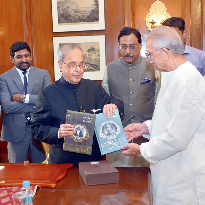 The poet presents both titles to Pranab Mukherjee, the President of India