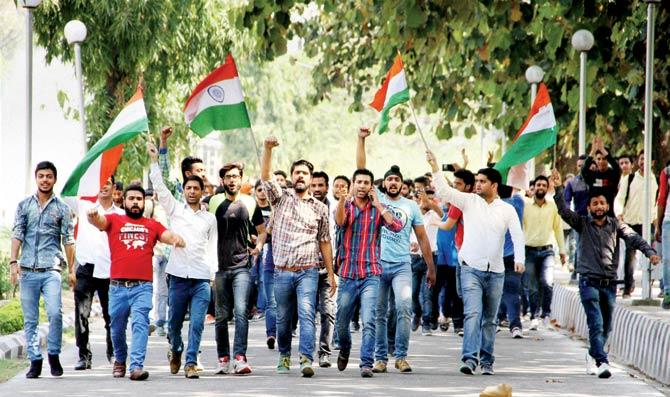 Students of Jammu University shout slogans during a protest rally against the police action on non-Kashmiri students. Pic/PTI