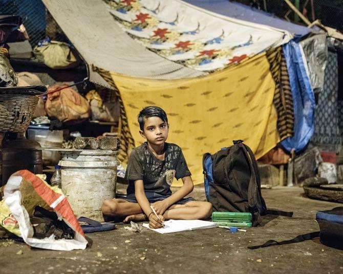 Vikram studies under the street lights. His parents want to ensure he gets an education that will allow him a different life from theirs