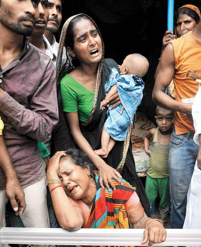 Relatives of a man killed in the collapse mourn their loss. Pics/PTI