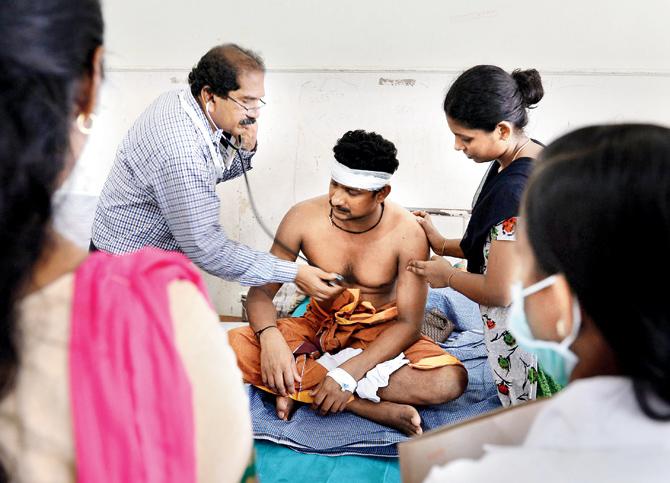 A doctor checks an injured at the Kollam District Hospital.