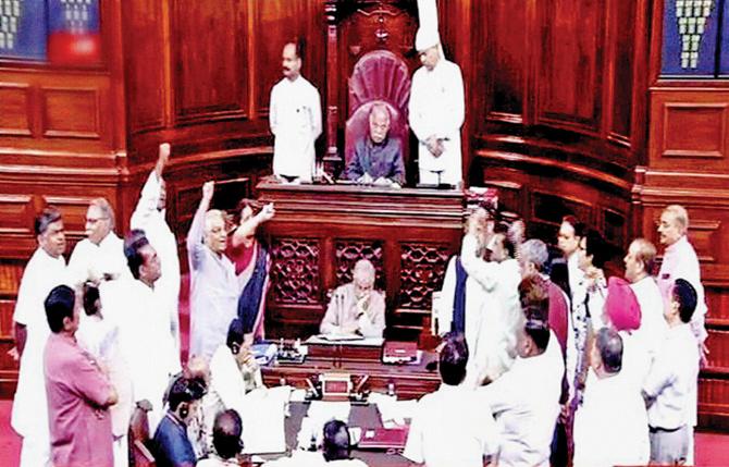 Members protest in the well of the Rajya Sabha PIC/PTI