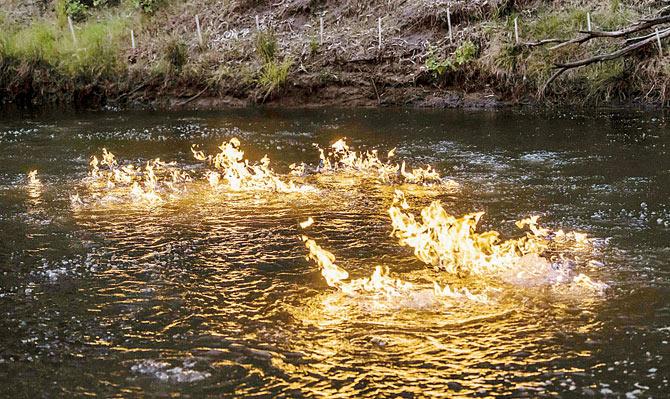 Methane gas on fire along Condamine River in Queensland. Pic/AFP