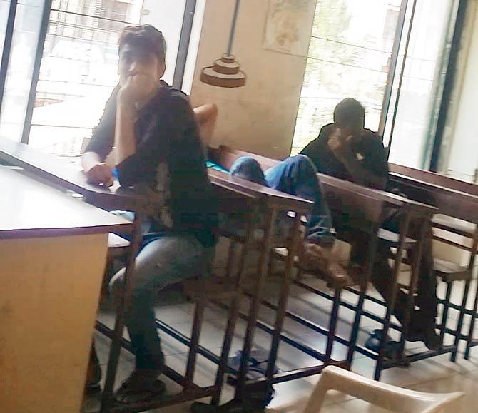 Youngsters ordered to do community service at a municipal school were spotted napping and playing games on their phones instead of cleaning the classrooms