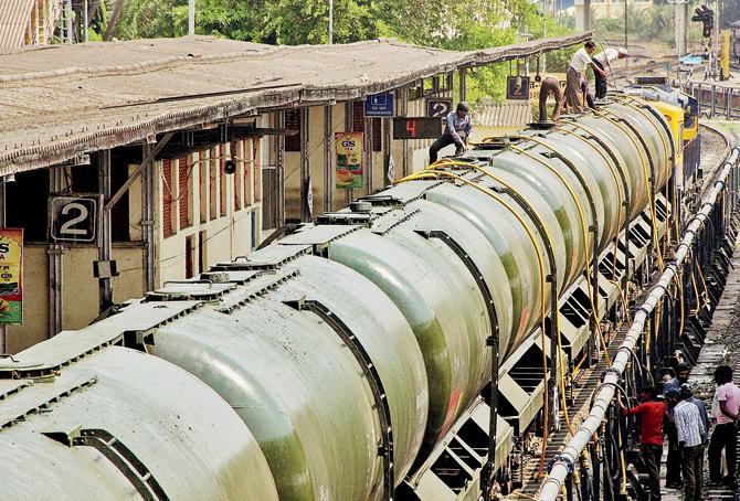 Workers fill water in the train tanks at  Miraj station near Sangli on Sunday. Pic/PTI