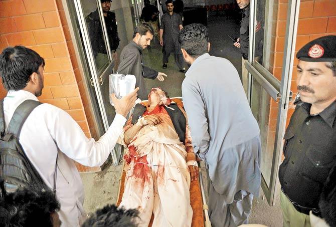 An injured being taken to a hospital in Peshawar. Pic/AFP