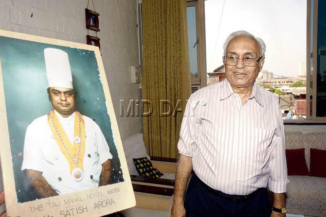 Satish Arora at his Colaba residence with a portrait of himself as a young Taj chef. Pic/Pradeep Dhivar