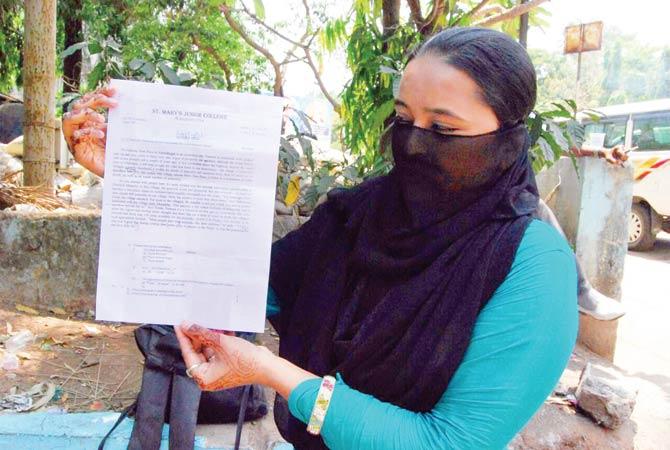 Shahin Liyakat Khan displays the English question paper she purchased on Thursday night