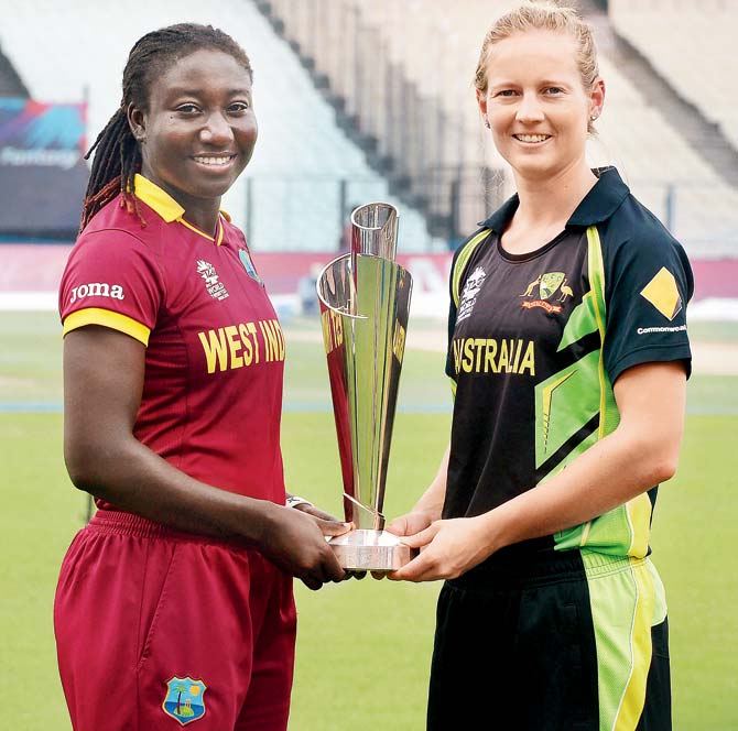 West Indies women’s team captain Stafanie Taylor (left) and Australia captain Meg Lanning pose with the World T20 trophy at Eden Gardens on Saturday. Pic/AFP