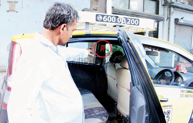 A taxi driver working with the Apna Cabs points at the prototype (circled) installed inside his vehicle. Pic/Ajinkya Sawant