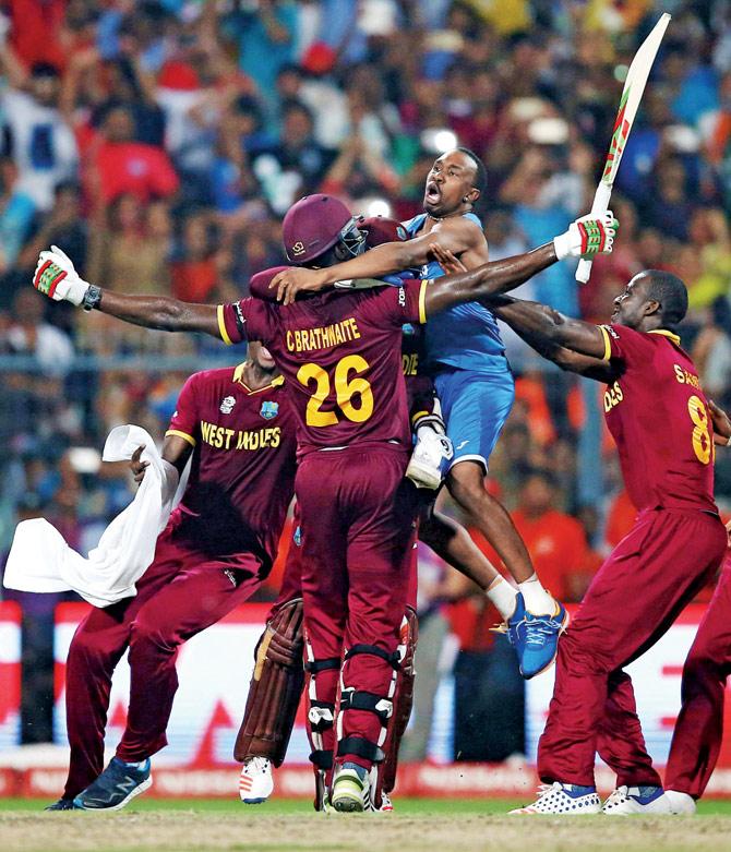 All-rounder Dwayne Bravo (in blue) celebrates West Indies