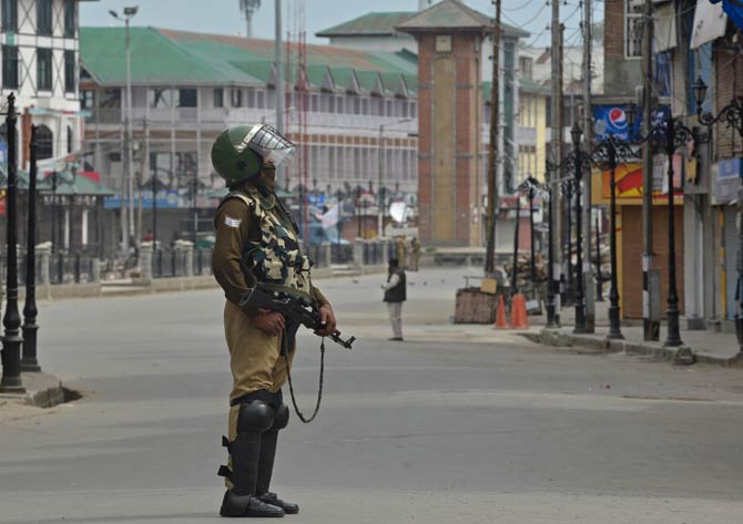 An Indian paramilitary trooper stands guard during a tense curfew in Srinagar on Friday. Pic/AFP