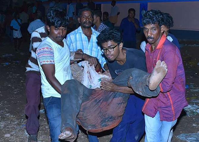 carry an injured man after an explosion and fire at The Puttingal Devi Temple in Paravur early April 10, 2016. A major explosion and fire swept through a temple in southern India killing 79 people after families and others had gathered for a fireworks display, a top official said