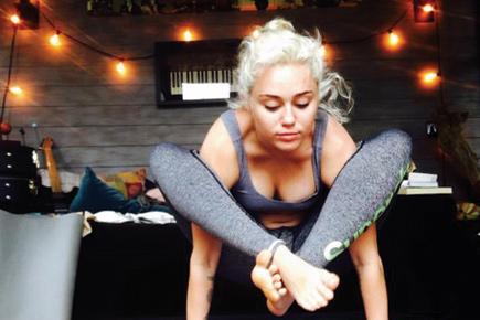 Miley Cyrus shows off yoga pose