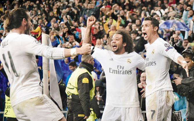 Cristiano 3 - Wolfsburg 0: Real’s Cristiano Ronaldo (extreme right) celebrates his goal with teammates during their quarters match against Wolfsburg at Madrid on Tuesday. Pic/AFP