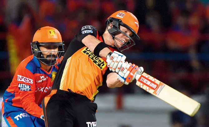Sunrisers Hyderabad skipper David Warner (right) slams one en route his 48-ball 74 not out against Gujarat Lions in an IPL-9 match at the Saurashtra Cricket Association Stadium in Rajkot.