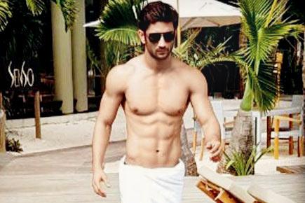 Fab abs! Sushant Singh Rajput chills by the poolside wearing a towel