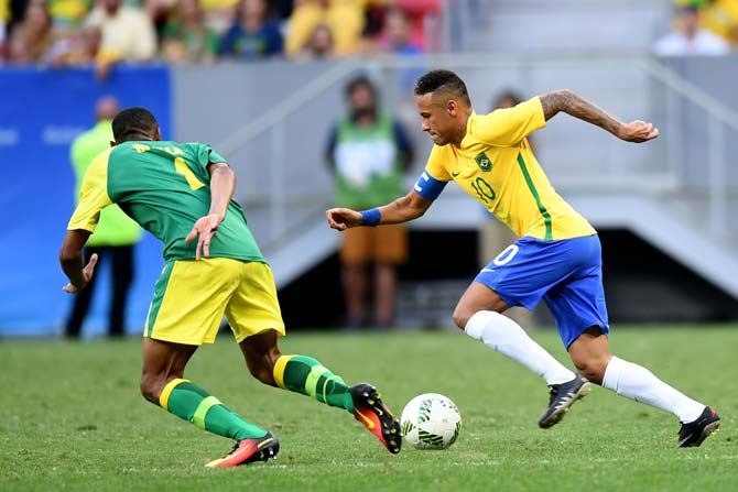 Brazil player Neymar (R) vies for the ball with South Africa player Mothobi Mvala. Pic/ AFP