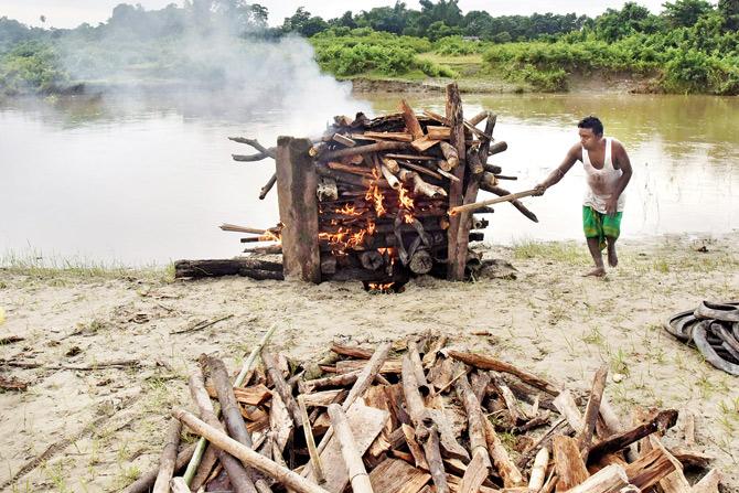  The body of Tapon Chakrabty, who was killed during a militant attack on a market at Balajan Tiniali, is cremated in the Kokrajhar district of Assam on Saturday. Pic/AFP