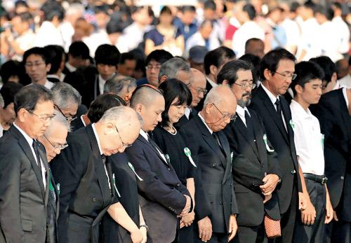 People offer a silent prayer during the 71st memorial service for the  A-bomb victims at the memorial park. Pics/AFP