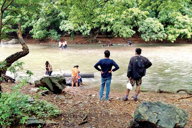 Visitors step into a stream in Sanjay Gandhi National Park (SGNP)