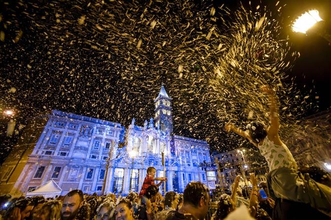 People enjoyed with snowfall soap foam as they participated during the historical re-enactment " The miracle of summer snow " in front of the Basilica of Santa Maria Maggiore, in central Rome last week