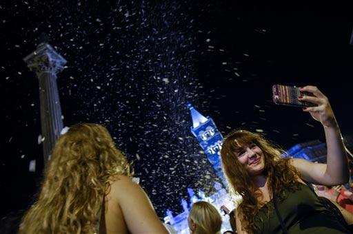 People enjoyed with snowfall soap foam as they participated during the historical re-enactment " The miracle of summer snow " in front of the Basilica of Santa Maria Maggiore, in central Rome last week