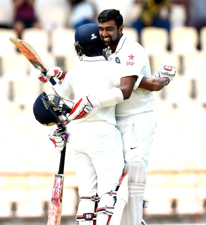 Wriddhiman Saha (L) and Ravichandran Ashwin hug in celebration of both of their centuries during day 2 of the 3rd Test between West Indies and India at Darren Sammy National Cricket Stadium Gros Islet, St. Lucia. Pic/AFP