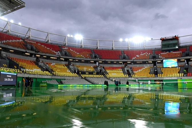 A photo taken on August 10, 2016 shows the emtpy stands of the Centre Court as play is interrupted due to rain at the Olympic Tennis Centre of the Rio 2016 Olympic Games in Rio de Janeiro. Pic/AFP